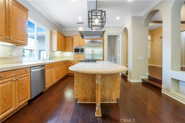 12160 Glines Ct, Tustin, CA 92782 - kitchen with built in appliances, dark wood finished floors, light countertops, a kitchen island, and ornamental molding