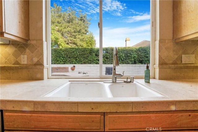 12160 Glines Ct, Tustin, CA 92782 - kitchen featuring a sink, light countertops, and backsplash