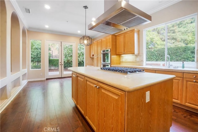 12160 Glines Ct, Tustin, CA 92782 - kitchen with island range hood, crown molding, appliances with stainless steel finishes, dark wood finished floors, and light countertops