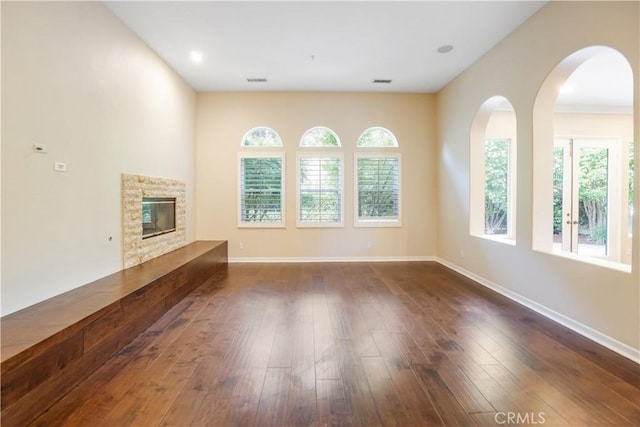 12160 Glines Ct, Tustin, CA 92782 - unfurnished living room featuring healthy amount of natural light, dark wood-style floors, and baseboards