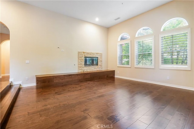 12160 Glines Ct, Tustin, CA 92782 - unfurnished living room featuring arched walkways, hardwood / wood-style floors, and healthy amount of natural light