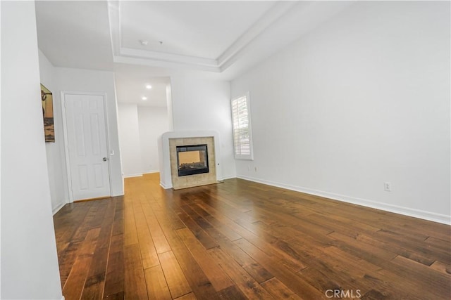 12160 Glines Ct, Tustin, CA 92782 - unfurnished living room with dark wood finished floors, a raised ceiling, and a tile fireplace