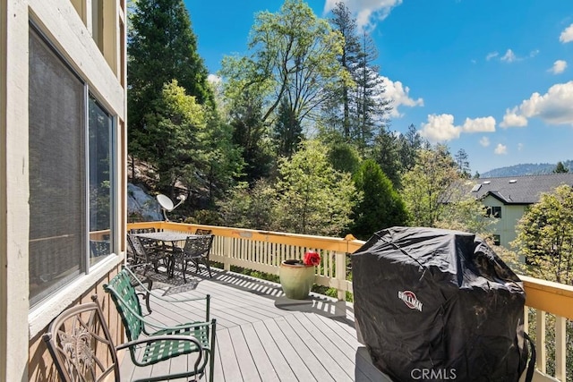 27495 Cedarwood Dr, Lake Arrowhead, CA 92352 - wooden deck with outdoor dining space and area for grilling