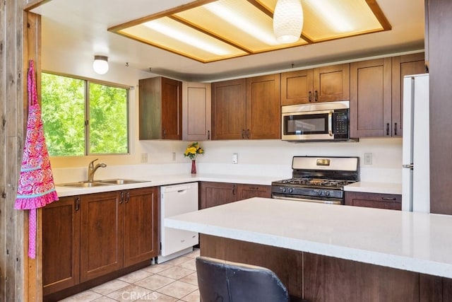 27495 Cedarwood Dr, Lake Arrowhead, CA 92352 - kitchen with appliances with stainless steel finishes, a sink, light countertops, and light tile patterned floors
