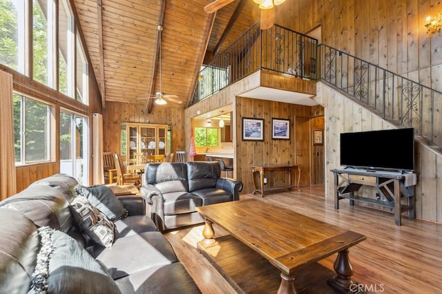 27495 Cedarwood Dr, Lake Arrowhead, CA 92352 - living room featuring a ceiling fan, high vaulted ceiling, wood walls, wooden ceiling with exposed beams, and wood finished floors
