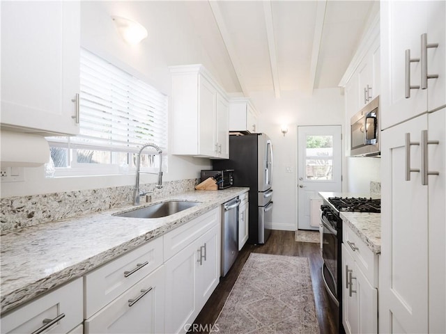 4239 Ish Dr, Simi Valley, CA 93063 - kitchen featuring stainless steel appliances, a sink, white cabinetry, dark wood-style floors, and light stone countertops