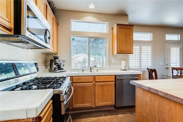 8961 Newcastle Ave, Hesperia, CA 92344 - kitchen featuring stainless steel appliances, tile counters, a sink, healthy amount of natural light, and recessed lighting