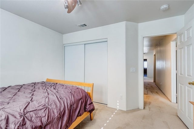 8961 Newcastle Ave, Hesperia, CA 92344 - bedroom with light colored carpet, a closet, baseboards, and a ceiling fan
