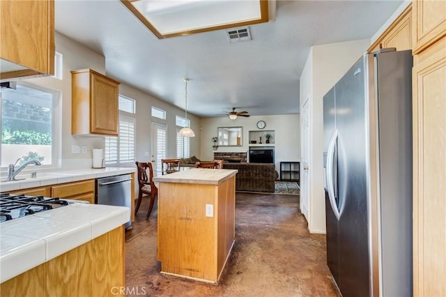 8961 Newcastle Ave, Hesperia, CA 92344 - kitchen featuring stainless steel appliances, open floor plan, a ceiling fan, a center island, and a sink