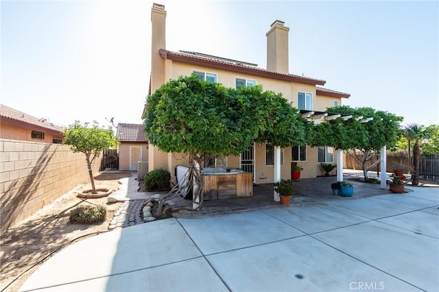 8961 Newcastle Ave, Hesperia, CA 92344 - back of house with a patio area, stucco siding, a chimney, and a fenced backyard