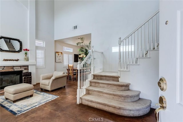 8961 Newcastle Ave, Hesperia, CA 92344 - stairs with a towering ceiling, concrete flooring, and a fireplace