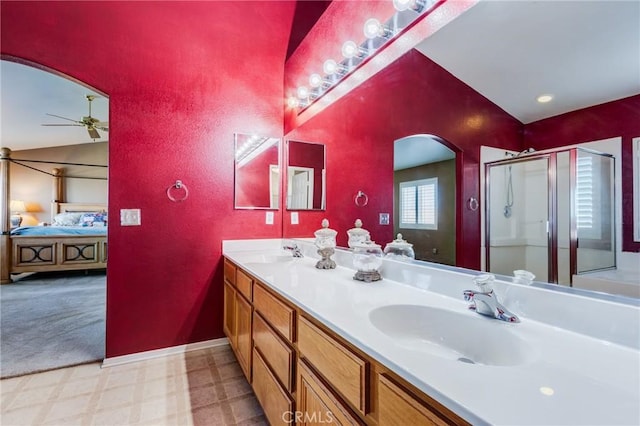 8961 Newcastle Ave, Hesperia, CA 92344 - ensuite bathroom featuring tile patterned floors, double vanity, a shower stall, a ceiling fan, and baseboards
