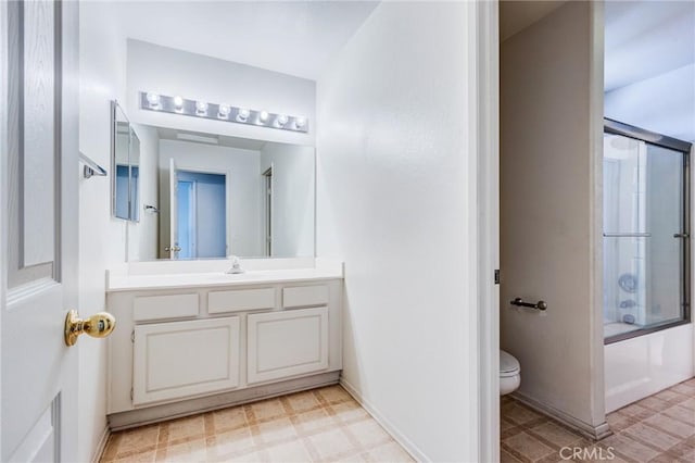8961 Newcastle Ave, Hesperia, CA 92344 - bathroom with toilet, tile patterned floors, vanity, shower / bath combination with glass door, and baseboards