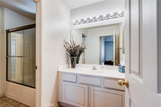 8961 Newcastle Ave, Hesperia, CA 92344 - bathroom featuring vanity and bath / shower combo with glass door