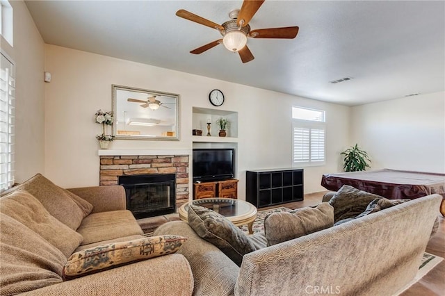 8961 Newcastle Ave, Hesperia, CA 92344 - living room with ceiling fan and a stone fireplace