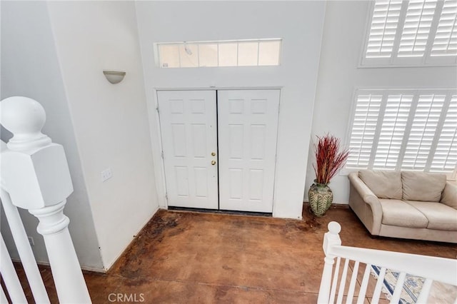 8961 Newcastle Ave, Hesperia, CA 92344 - entrance foyer featuring concrete flooring, plenty of natural light, a towering ceiling, and baseboards