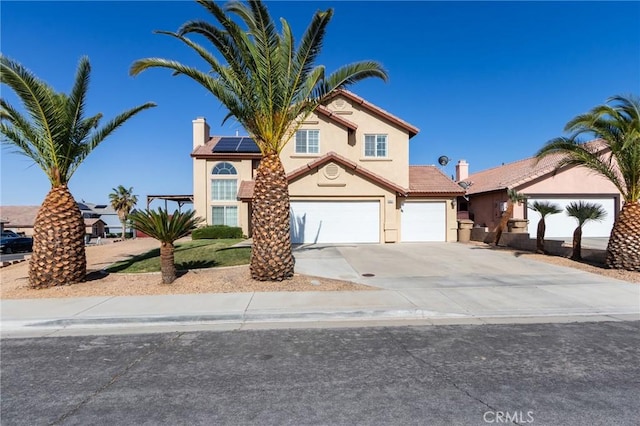 8961 Newcastle Ave, Hesperia, CA 92344 - traditional-style house featuring stucco siding, concrete driveway, solar panels, a garage, and a chimney