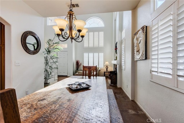 8961 Newcastle Ave, Hesperia, CA 92344 - dining area featuring plenty of natural light, a chandelier, baseboards, a textured wall, and dark carpet