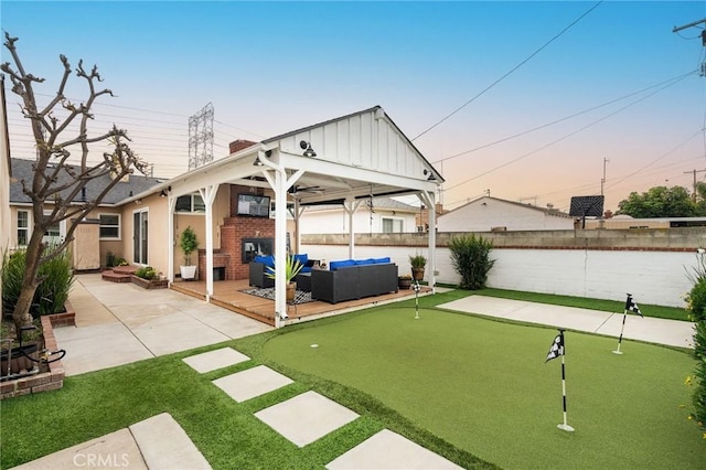 6003 Eastbrook Ave, Lakewood, CA 90713 - fenced backyard with a putting area, outdoor lounge area, a patio area, and a gazebo
