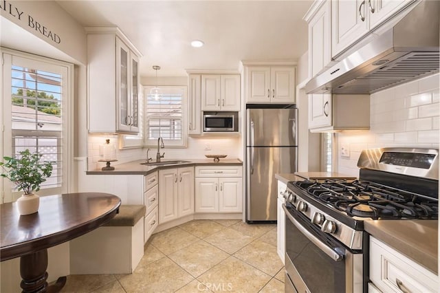 6003 Eastbrook Ave, Lakewood, CA 90713 - kitchen with appliances with stainless steel finishes, under cabinet range hood, healthy amount of natural light, tasteful backsplash, and recessed lighting