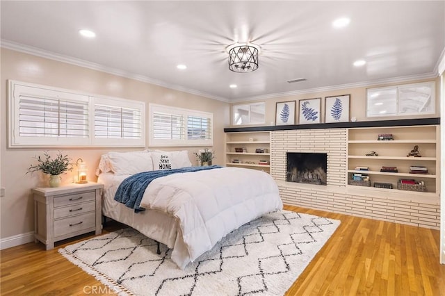 6003 Eastbrook Ave, Lakewood, CA 90713 - bedroom featuring crown molding, wood finished floors, recessed lighting, and a fireplace