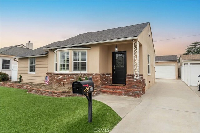 6003 Eastbrook Ave, Lakewood, CA 90713 - view of front of house with a front lawn, roof with shingles, brick siding, and a garage