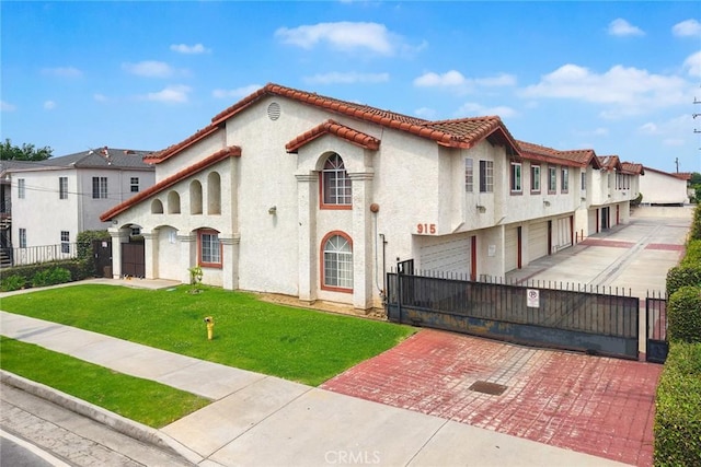 915 Carob Way Unit 2, Montebello, CA 90640 - view of front facade featuring stucco siding, a gate, a tile roof, and decorative driveway