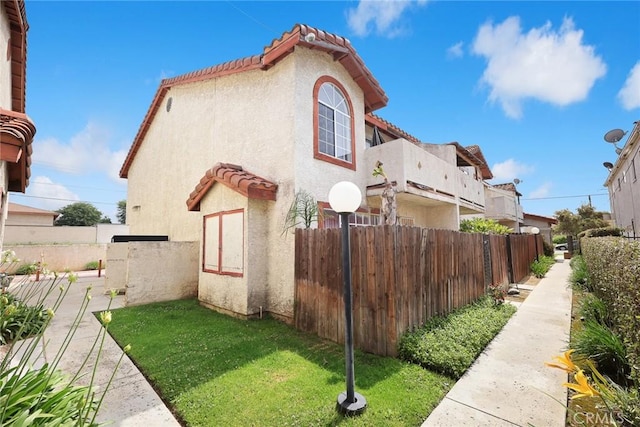 915 Carob Way Unit 2, Montebello, CA 90640 - view of property exterior featuring stucco siding and a tile roof