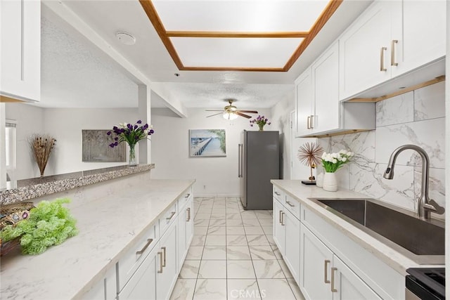 915 Carob Way Unit 2, Montebello, CA 90640 - kitchen featuring freestanding refrigerator, a sink, light marble finish floors, range with gas cooktop, and white cabinets