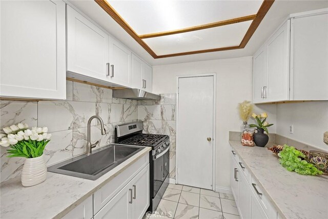 915 Carob Way Unit 2, Montebello, CA 90640 - kitchen with gas stove, a sink, under cabinet range hood, and white cabinetry