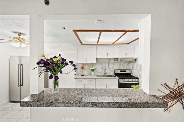 915 Carob Way Unit 2, Montebello, CA 90640 - kitchen featuring appliances with stainless steel finishes, a sink, backsplash, white cabinetry, and a ceiling fan