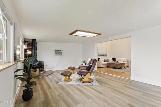2791 Elizondo Ave, Simi Valley, CA 93065 - sitting room featuring wood finished floors, a wood stove, and a wall unit AC