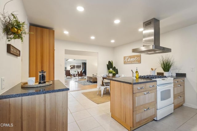 2791 Elizondo Ave, Simi Valley, CA 93065 - kitchen with island exhaust hood, white range with gas cooktop, dark countertops, light tile patterned floors, and recessed lighting