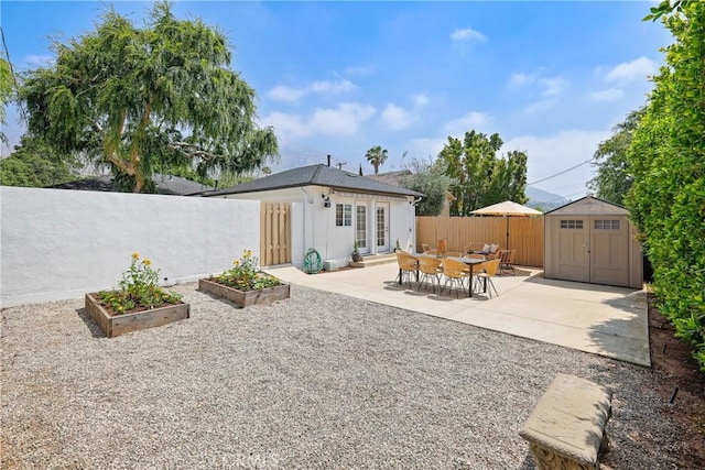 2482 New York Dr, Altadena, CA 91001 - rear view of house featuring a vegetable garden, a fenced backyard, a patio, and french doors