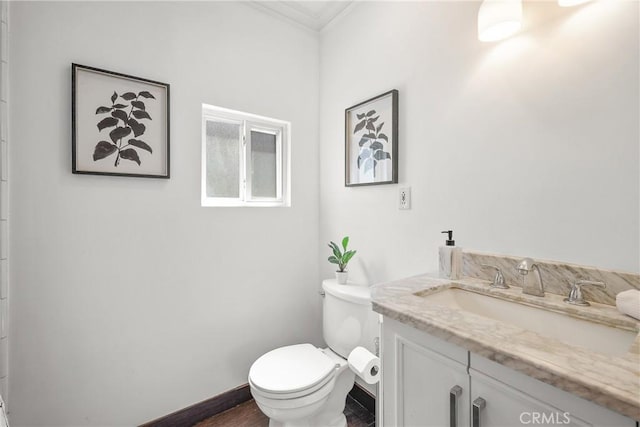 2482 New York Dr, Altadena, CA 91001 - bathroom featuring toilet, vanity, ornamental molding, baseboards, and wood finished floors