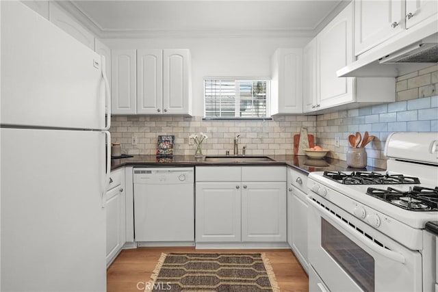 2482 New York Dr, Altadena, CA 91001 - kitchen with white appliances, a sink, under cabinet range hood, dark countertops, and white cabinetry