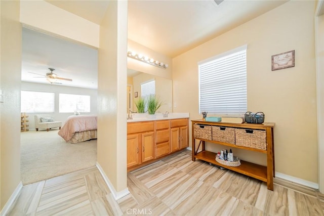 18427 Blue Sky St, Riverside, CA 92508 - bathroom with double vanity, connected bathroom, a ceiling fan, and baseboards