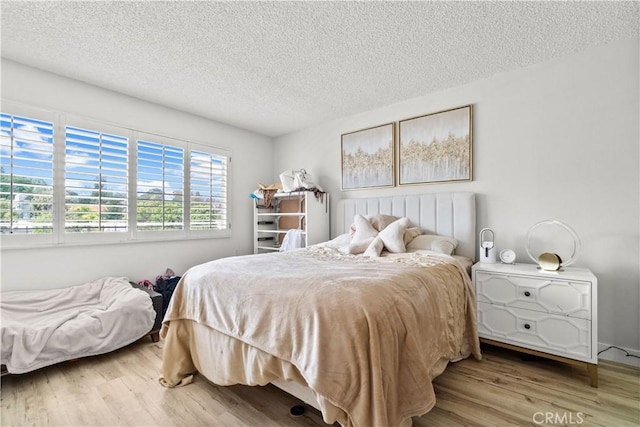 5369 Algarrobo Unit 3F, Laguna Woods, CA 92637 - bedroom featuring a textured ceiling, wood finished floors, and radiator