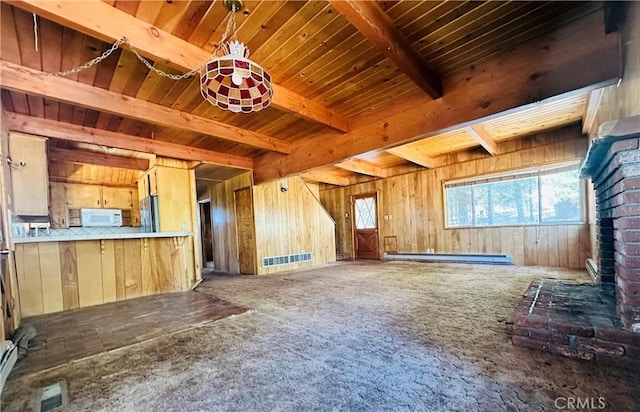 31506 Circle View Dr, Running Springs, CA 92382 - unfurnished living room featuring carpet, wood walls, baseboard heating, and wooden ceiling with exposed beams