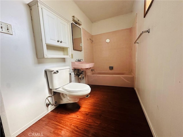 31506 Circle View Dr, Running Springs, CA 92382 - bathroom featuring wood finished floors, toilet, baseboards, and washtub / shower combination