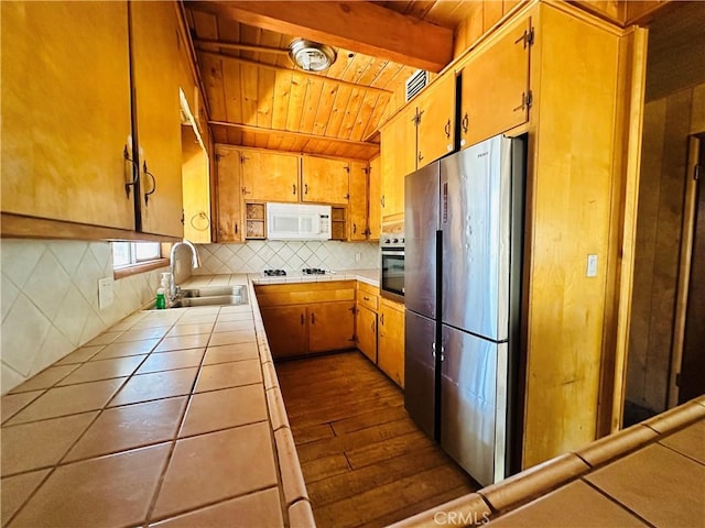 31506 Circle View Dr, Running Springs, CA 92382 - kitchen with tile counters, stainless steel appliances, a sink, backsplash, and wooden ceiling with exposed beams