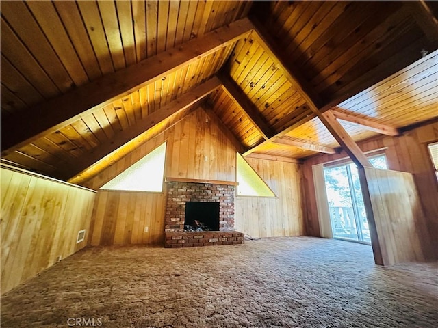 31506 Circle View Dr, Running Springs, CA 92382 - unfurnished living room with wooden walls, carpet, plenty of natural light, wooden ceiling with exposed beams, and a fireplace