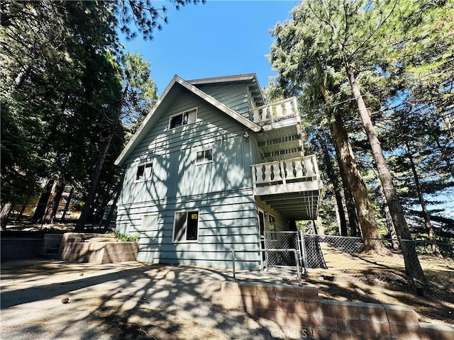 31506 Circle View Dr, Running Springs, CA 92382 - view of property exterior featuring a balcony and a gate