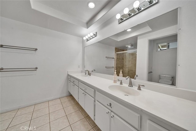 19545 Quicksilver Ln, Rowland Heights, CA 91748 - bathroom with double vanity, toilet, a tray ceiling, a shower stall, and tile patterned flooring