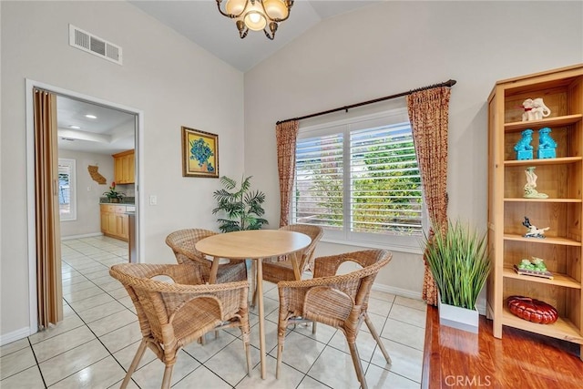 19545 Quicksilver Ln, Rowland Heights, CA 91748 - dining space featuring light tile patterned floors, high vaulted ceiling, baseboards, and a chandelier