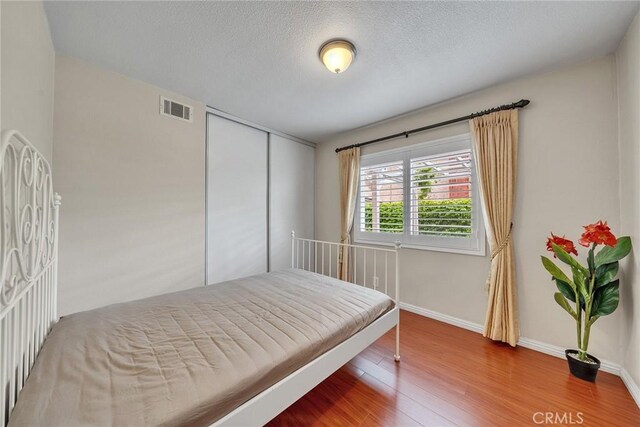 19545 Quicksilver Ln, Rowland Heights, CA 91748 - bedroom with wood finished floors, baseboards, a textured ceiling, and a closet