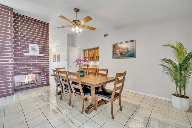 19545 Quicksilver Ln, Rowland Heights, CA 91748 - dining space featuring light tile patterned flooring, a ceiling fan, a brick fireplace, baseboards, and lofted ceiling