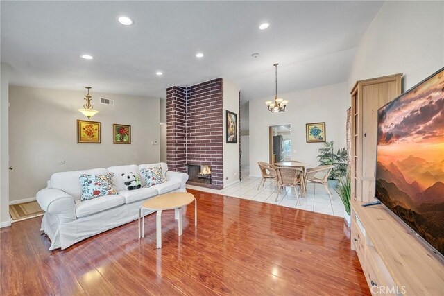 19545 Quicksilver Ln, Rowland Heights, CA 91748 - living area featuring a brick fireplace, a chandelier, baseboards, and recessed lighting