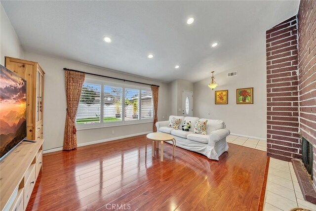 19545 Quicksilver Ln, Rowland Heights, CA 91748 - living room with vaulted ceiling, light wood-type flooring, recessed lighting, baseboards, and a fireplace