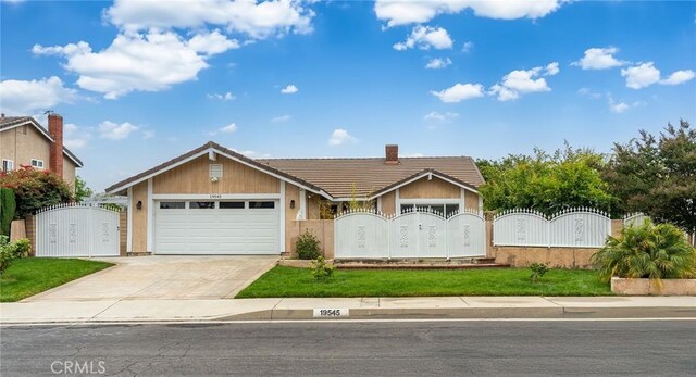 19545 Quicksilver Ln, Rowland Heights, CA 91748 - view of front facade with a gate, a tiled roof, an attached garage, driveway, and a fenced front yard